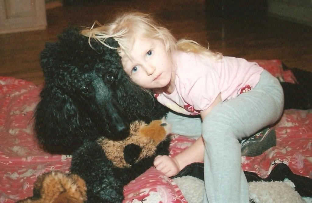 photo of child and standard poodle